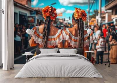 Two beautiful women in traditional folk costumes with intricate braided hair, strolling through an American town during the day. The woman on the right, taller with a long black ponytail, and both wea Wall mural