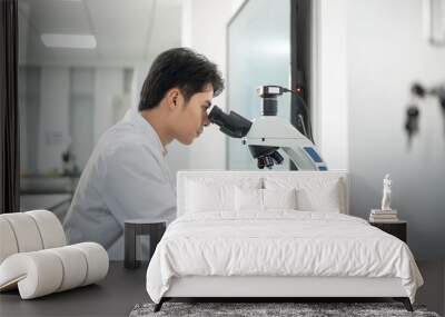 doctor using microscope in lab Wall mural