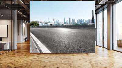 empty asphalt highway street with city skyline Wall mural