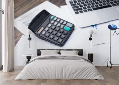 laptop and calculator on financial report Wall mural