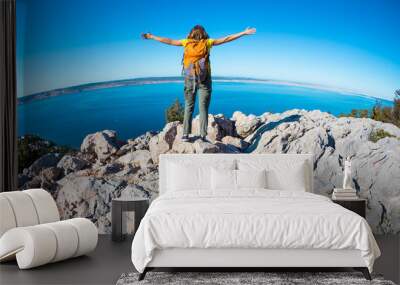 Girl on the background of the sea and mountains. Wall mural