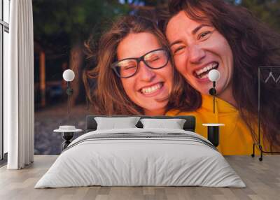 Two happy woman friends laughing Wall mural