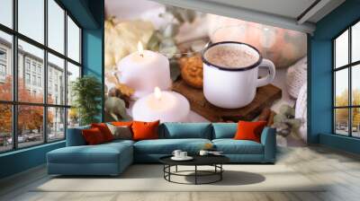 Hot cocoa with cookies in a white mug surrounded by autumn leaves and pumpkins Wall mural