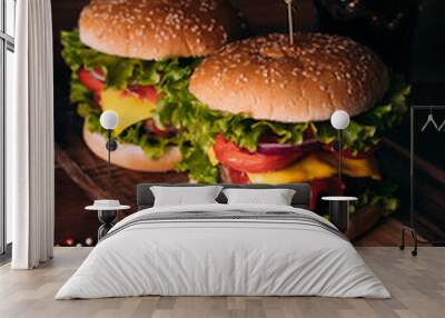 Two home made fresh tasty burgers with lettuce and cheese on wooden table. Wall mural