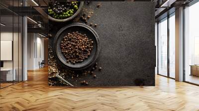 Black pepper in various forms; raw, dried and crushed peppercorns on a black background with space for text Wall mural