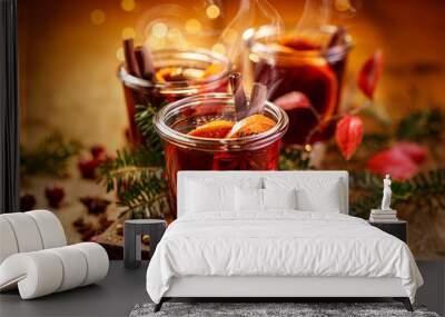 Christmas mulled red wine with aromatic spices and citrus fruits on a wooden rustic table, close-up. Traditional hot drink at Christmas time Wall mural