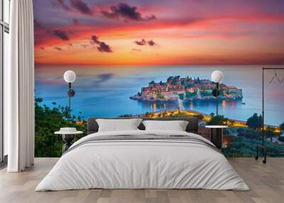 Amaizing sunset view on Sveti Stefan Island City. Small islet and resort in Montenegro. Balkans, Adriatic sea, Europe. Dramatic red sky under a Saint Stefan peninsula. Wall mural