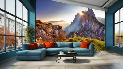 Amazing view on Seceda peak. Trentino Alto Adige, Dolomites Alps, South Tyrol, Italy, Europe. Odle mountain range, Val Gardena. Majestic Furchetta peak. Purple flowers in the morning sunlight. Wall mural