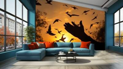 Easter Sunday concept: Silhouette scars in hands of Jesus Christ with birds flying on sunrise Wall mural