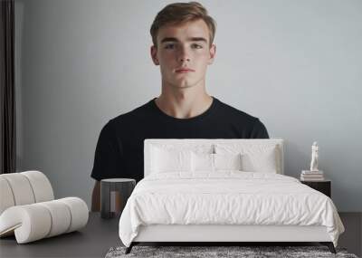 Young Man in a Black T-Shirt Against a White Background Wall mural