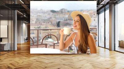 Coffee ads. Beautiful woman take cappuccino with Italian landscape on background. Copy space for advertising. Wall mural