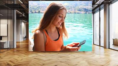 Cruise ship woman using mobile phone on travel vacation. Girl texting sms or using Wifi Internet. Tourist looking at her holidays pictures.
 Wall mural