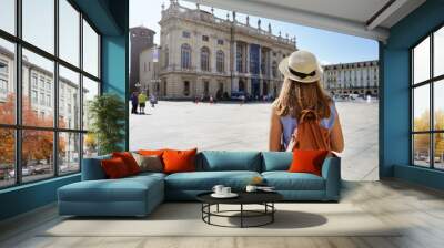 Cultural tourism in Europe. Back view of female tourist visiting Turin, Italy. Wall mural