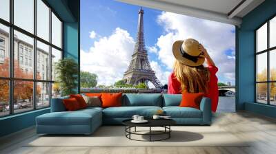 Holidays in Paris. Back view of beautiful fashion girl enjoying view of Eiffel Tower in Paris, France. Summer vacation in Europe. Wall mural