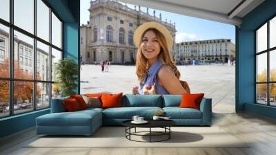 Smiling beautiful girl visiting Europe. Portrait of fashion tourist woman walking in Turin, Italy. Wall mural