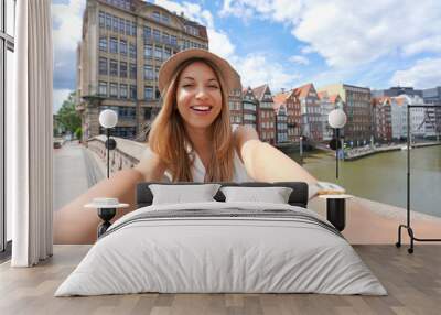 Traveler girl taking self portrait in Hamburg, Germany Wall mural