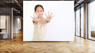 Portrait of asian little child girl gesture hands spread her fingers on white background. Focus at kid hands Wall mural