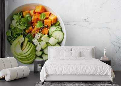 a salad featuring avocado, cucumber, and grilled sweet potato on a white background, with no shadows in the center, ideal for text or copy space. Wall mural