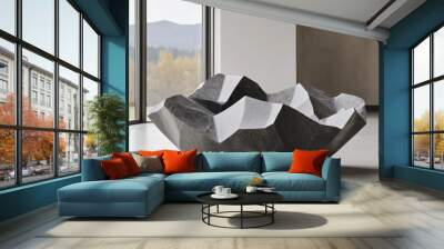 A solid stone sculpture with smooth curves stands prominently in an office lobby, enhanced by natural light that creates intriguing shadows and highlights Wall mural