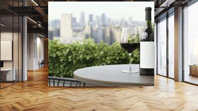 Two wine glasses and a bottle sit on a wooden table overlooking a city skyline as the sun sets, creating a serene atmosphere for relaxation. Wall mural