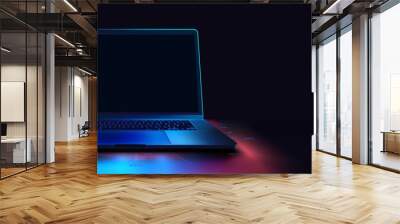 Futuristic mockup Laptop with Blue Backlight on Dark Background. A 3D illustration of an open laptop illuminated by a neon blue light on a dark backdrop, showcasing modern technology and connectivity. Wall mural