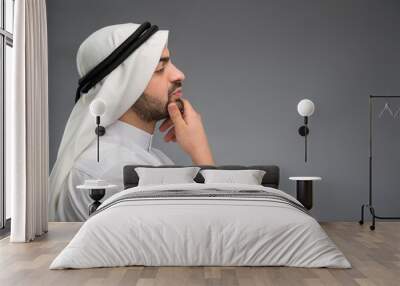 Arab man thinking hard with hand on his face Wall mural