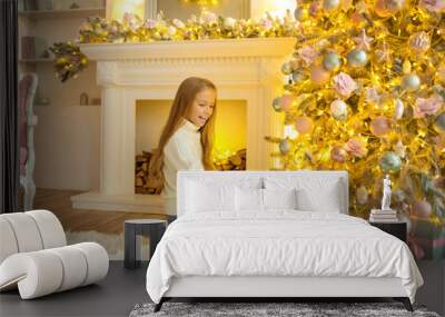 Blonde cute girl looking busy looking at the christmas presents Wall mural