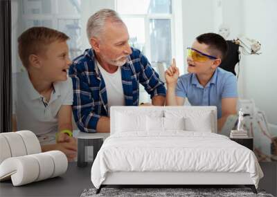 Brilliant solution. Nice smart boy looking at his teacher while sharing his idea Wall mural