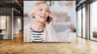 Cheery elderly woman calling her friend Wall mural