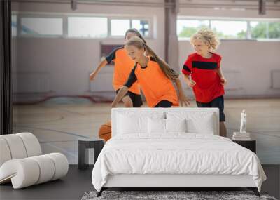 Children in bright sportswear playing basketball and looking excited Wall mural