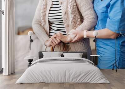 gentle trained nurse helping mature patient Wall mural