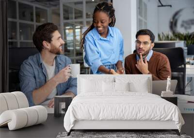 Group of diverse businesspeople using laptop while working together Wall mural