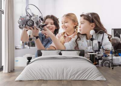 Joyful kids testing modern device at school Wall mural