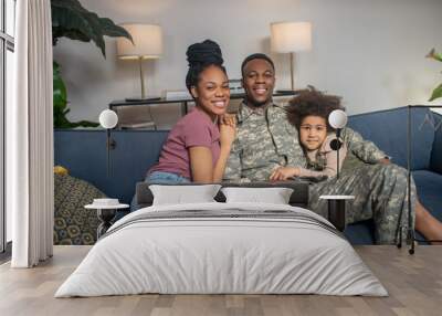 Little girl woman and military man sitting on couch Wall mural