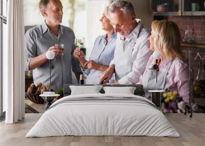 Mature friends having fun while making dinner Wall mural