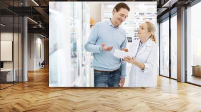 on this shelf. confident female pharmacist using tablet while speaking with man Wall mural