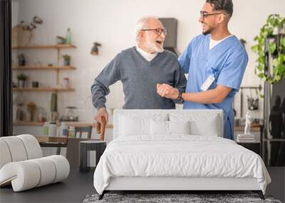 Patient leaning on the cane supported by a young nurse Wall mural