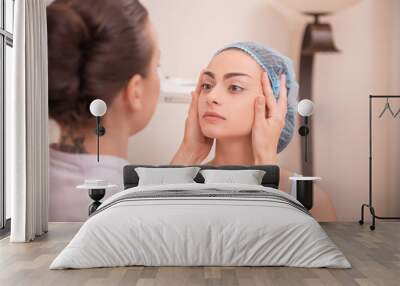 Portrait of a young woman with fresh and clean skin talking to h Wall mural