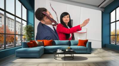 Portrait of young business woman  giving a  slap in the face to Wall mural