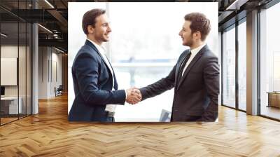 Positive business partners shaking hands Wall mural