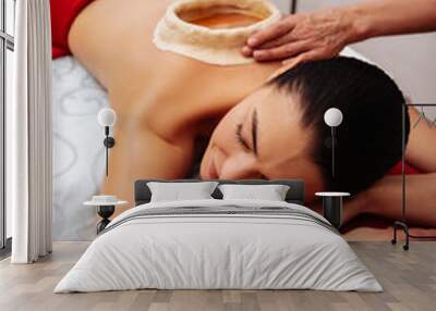 Relaxed long-haired woman resting on massage bed Wall mural