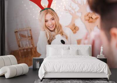 Smiling happy woman having a Christmas photoshoot Wall mural