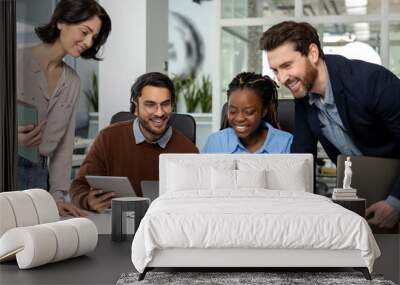 Team of multicultural businesspeople using laptop while working together Wall mural