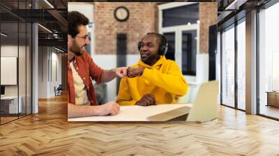 Two colleagues working together and looking excited Wall mural