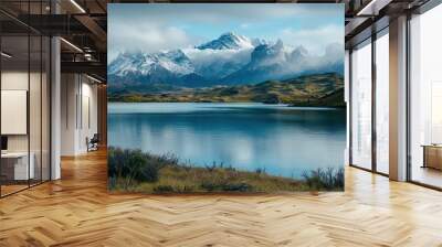 Serene mountain lake reflecting snow-capped peaks and clouds. Tranquil landscape of majestic mountains, blue lake, and natural beauty. Wall mural