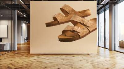 Flying on a beige backdrop are summertime vegan cork sandals with double straps. fashionable and fashionable women's slippers. Take a copy of space, Generative AI. Wall mural