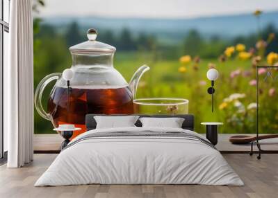 black tea in glass cup and teapot on summer outdoor background. copy space. Wall mural