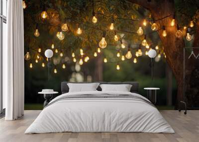 Decorative outdoor string lights hanging on tree in the garden at night time Wall mural