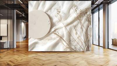 Empty round beige platform podium, dry tree twigs and bent grass on white linen fabric background. Minimal creative composition background for cosmetics or products presentation. Top view  Wall mural