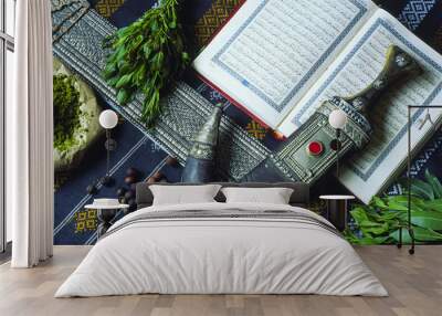 Quran, janbiya, henna and coffee on table Wall mural